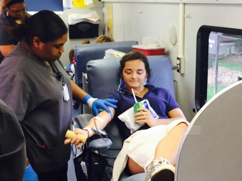 Tori Jones sips on a sugary drink as she donates blood