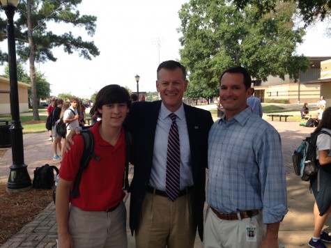 Junior Brendon McLeod (left) and Coach Will Crosby (right) with Mississippi State University athletic director Scott Stricklin, who led a discussion of the book "Benching Jim Crow" by Charles H. Martin.