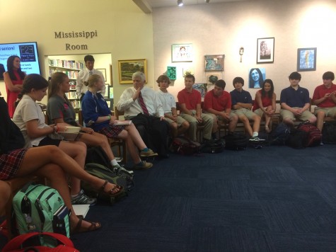 A group of students in the library talk to author and former Ole Miss Chancellor Dr. Robert Khayat.