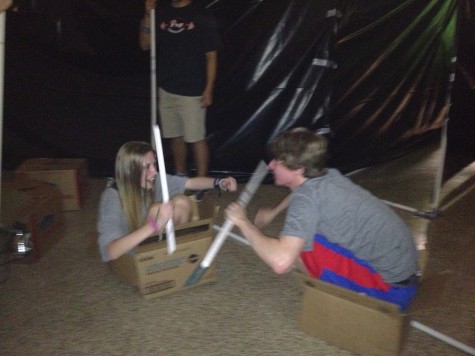 Hannah Hederman and Jackson Phillips, taking a break from literary haunted house construction, pvc-fighting while squooshed into boxes. Photo courtesy of Dr. Lisa Whitney