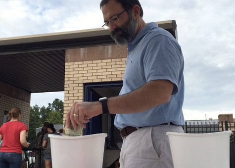 At the Oak Forest game, Prep parent Mr. Charles Pringle donates to help survivors of the flooding. Photo by Tanner McCraney.