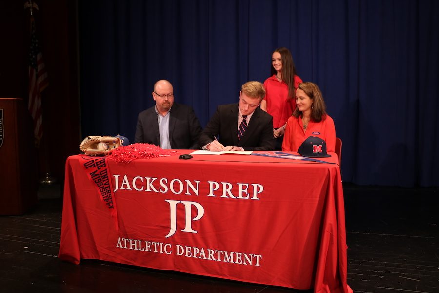 Matthew Myers signs his letter to Ole Miss where he will pitch for the Baseball team.  Photo by Stewart McCullough