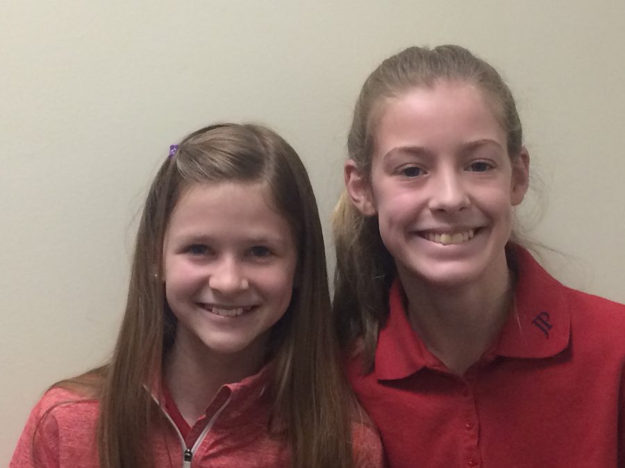 7th grade girls Anna Voynik and Havens Smith are excited for book club. Photo by John Henry Andress