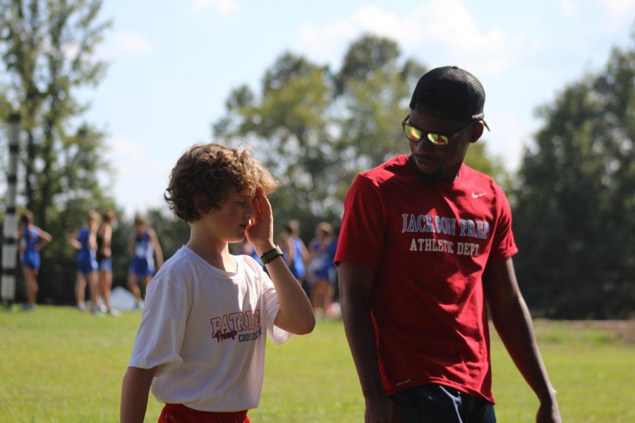 Coach Daniel Burnett encourages one of the runners before the race.