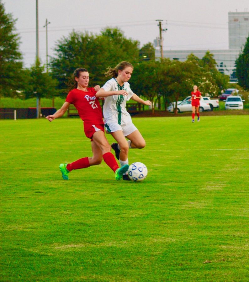 Kelsey making a defensive move at an opposing player during a Prep soccer game. Photo courtesy of Kelsey