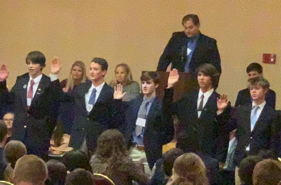 Youth Legislature governor-elect Cass Rutledge (far left) is sworn in along with other new officers, as outgoing governor Alex Stradinger (right, in back) watches.