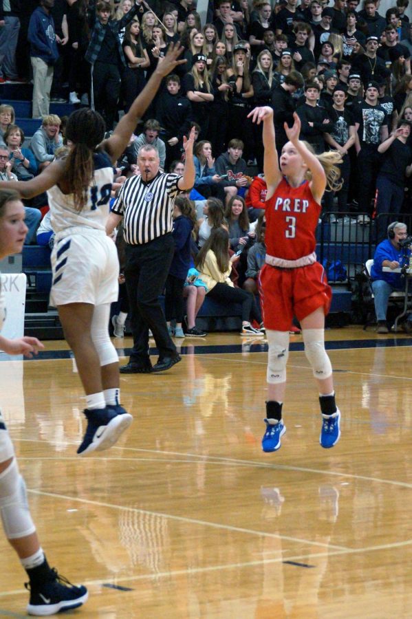 Andie Flatgard shoots a basket. 