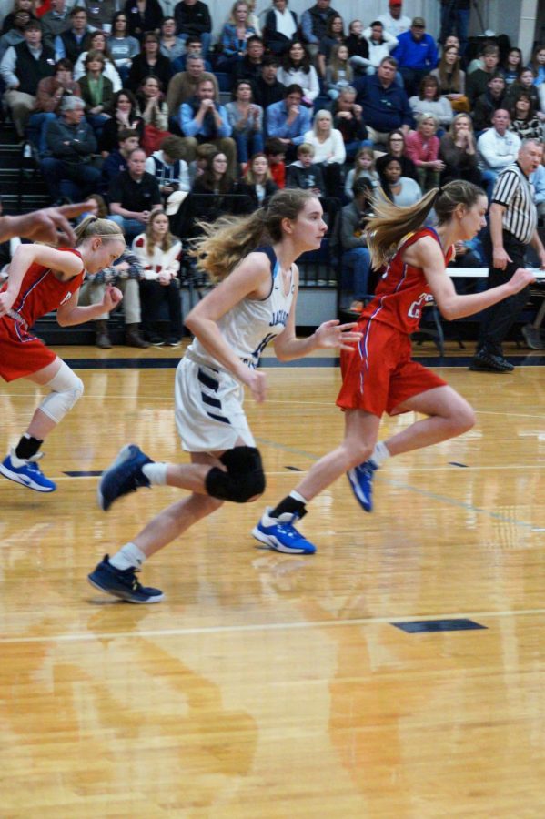 Julia Stradinger and Andie Flatgard race down the court.