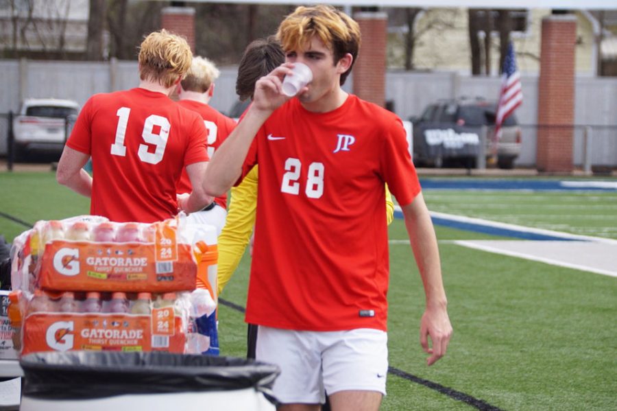 Owen Lundberg gets water after playing in the game.