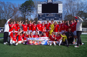 The team poses with the trophy after a hard fought game.