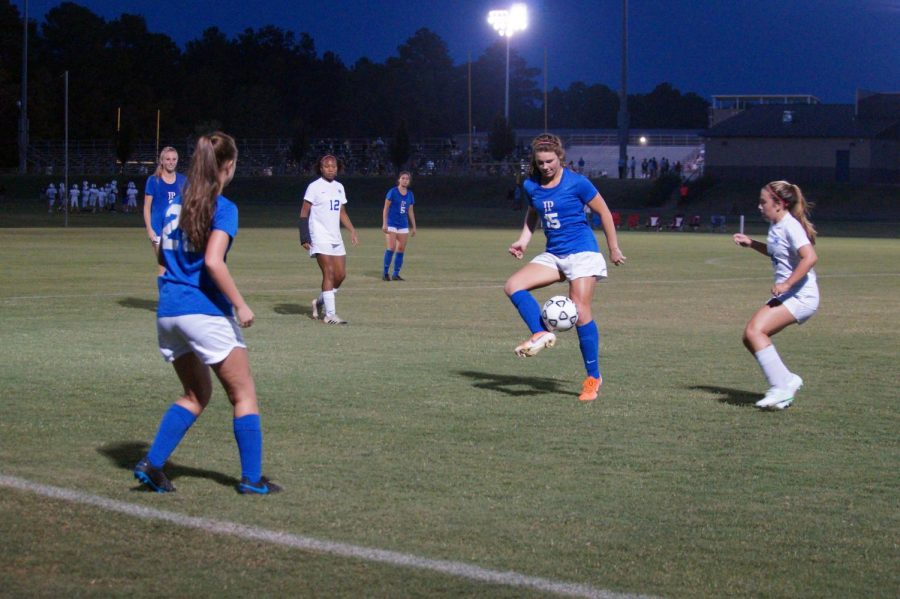 Olivia Sasser receives the  ball from a teammate.