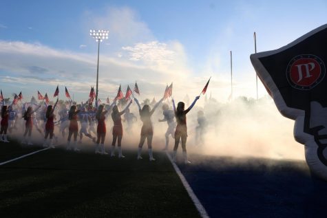 The Jackson Prep varsity football team runs out of the tunnel for the season opener against Heritage.