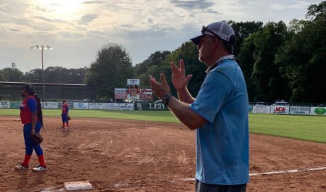 Coach Jay Powell coaching defense for the JV softball team.