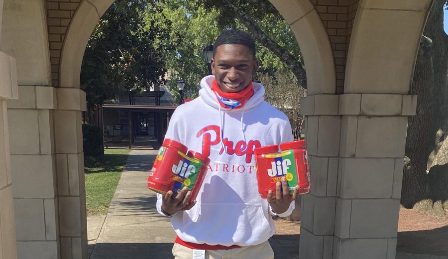 KD Smith holds up some of the peanut butter donated for the MAD Project