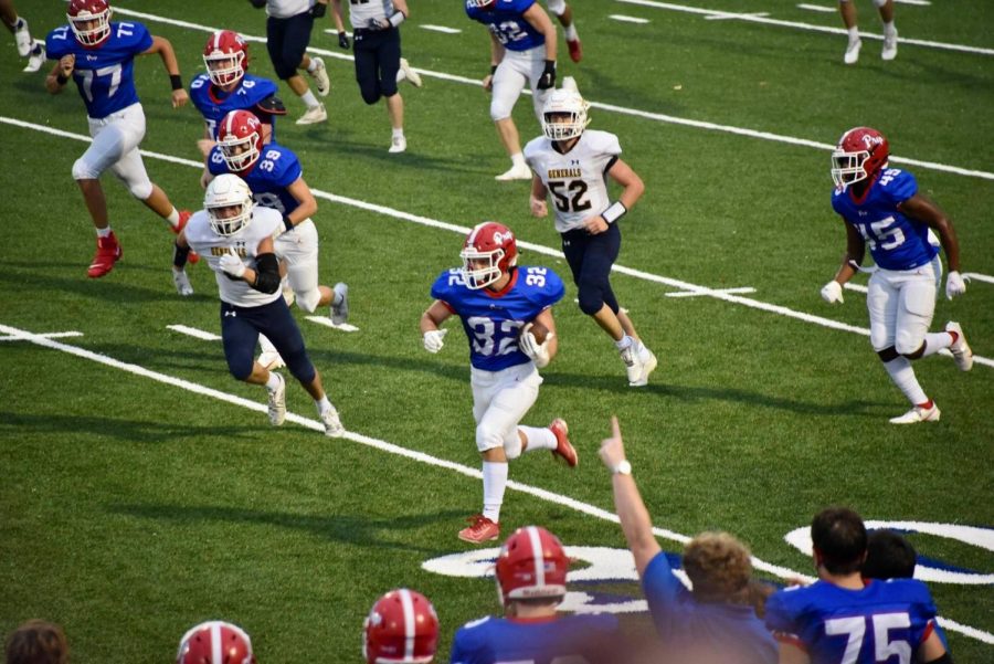 Sam McMullan rushes towards the endzone to extend the Patriots lead. Photo courtesy of Jennifer Mooneyham