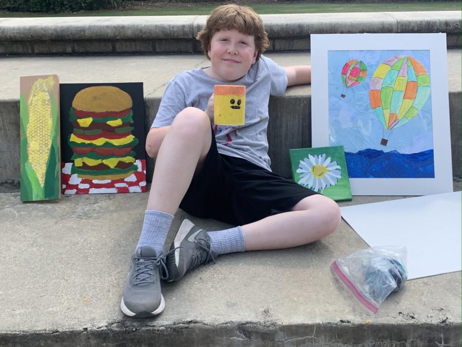 A Prep summer camper shows off a weeks worth of art.