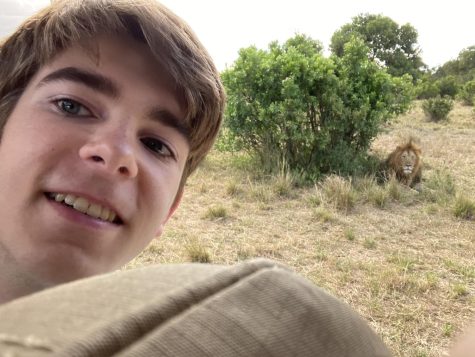 Baty Newman takes a selfie with a lion.