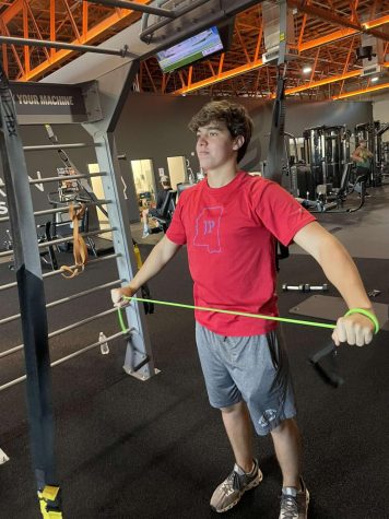 John Woods Hollowell uses resistance bands to train for his sport. Photo by: 