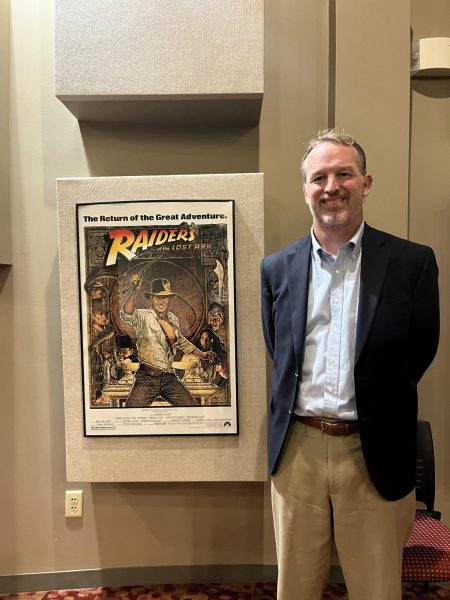 Head of School and movie lover Mr. Lawrence Coco with a poster of one of his all-time favorites