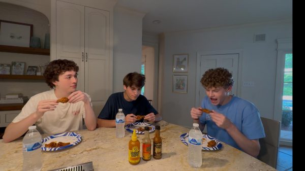 Preston (center) is interviewed over some hot wings, because it's 2025, and that's how we do things