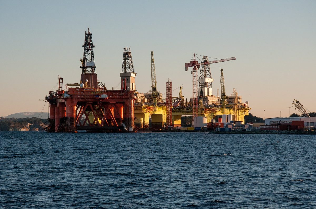 "Oil Rigs at Coast Center Base outside Bergen" by L.C. Nøttaasen via Wikimedia.